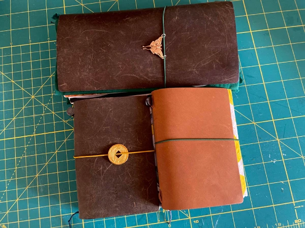 All 3 Traveler's Notebooks (olive regular, olive passport, and olive camel).