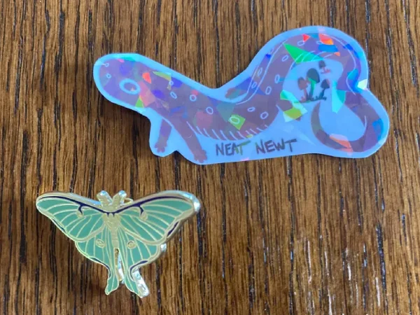 Sticker and a pin from Jade Doe