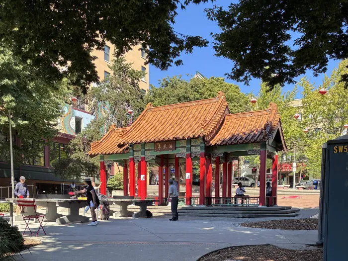 People playing ping pong in front of the Hing Hay pavillion