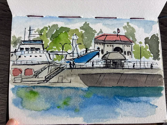 Ink and watercolor painting of the Ballard locks, facing the Carl S. English garden. There is a Flicka boat passing through the locks