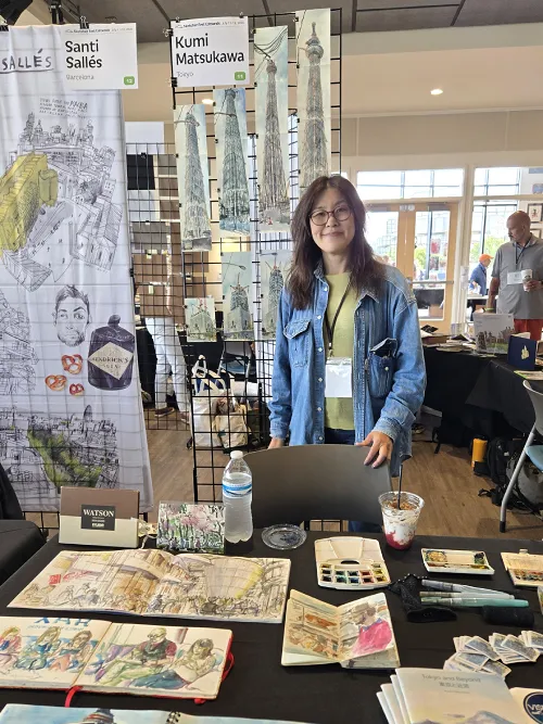 Photo of Kumi Matsukawa at her Sketchbook Fair table